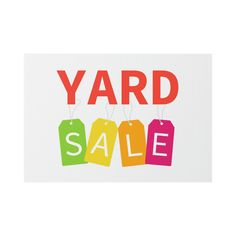 yard sale sign with colorful tags hanging from strings