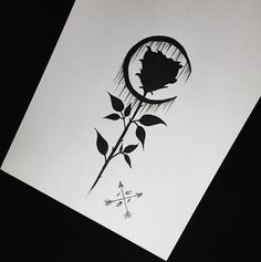 a black and white photo of a rose with an arrow in the middle is shown