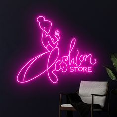 a neon sign that says fashion and store on the side of a wall next to a chair