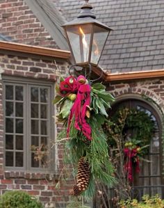 a christmas wreath hanging from a lamp post