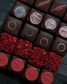 some chocolates with red wax on them are sitting next to each other and there is a bunch of coins in the middle