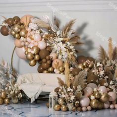 a bunch of balloons that are on top of a table with some flowers and other decorations