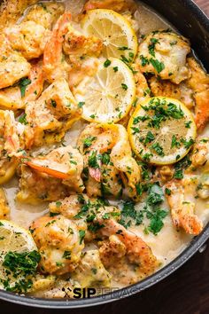 a skillet filled with shrimp and lemons