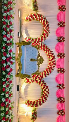 an elaborately decorated wedding stage with pink and white flowers