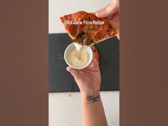 a hand holding up a slice of pizza with sauce in it and the word still alive pizza recipe written on it