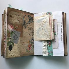 an open book with papers and lace on it