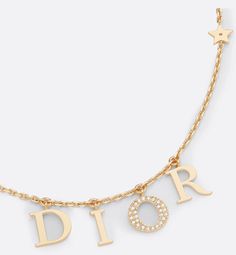 The Dio(r)evolution necklace is both elegant and timeless. The 'DIOR' letters are suspended on a gold-finish metal chain, and the letter 'O' is in a pavé of white crystals to add shimmer to the neck. The effortless style can be worn with other creations from the Dio(r)evolution line.. Dior Jewelry Aesthetic, Dior Necklace Gold, Sweet 16 Jewelry, Dior Necklace, Fine Gold Necklace, Pretty Jewelry Necklaces, Expensive Jewelry Luxury, Dior Jewelry, White Crystals