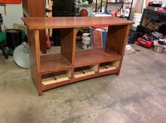 a wooden shelf sitting inside of a garage