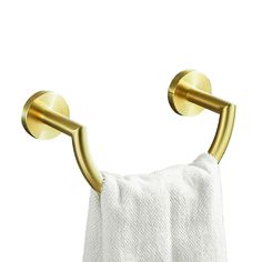 a towel hanging on the side of a wall with two gold hooks attached to it