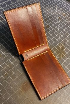 Traditional bifold - Tobacco Red  * This wallet is 100% handmade * includes 8 card pockets with a full size cash pocket  * leather colors are Tobacco Red and Double Black * Wickett & Craig natural vegetable tanned leather * The leather is dyed, oiled and waxed by hand. * hand punched and saddle stitched,  burnished and waxed edges.  * We seal each wallet with Aussie cream, it gives the wallet heat, cold, water and scratch resistance without changing how the wallet looks or feels.  * Lifetime guarantee  If you have any questions or a custom order request, please feel free to send me a message. For any other details you can go to our website www.benningtonleather.com Cognac Bifold Wallet With Coin Pocket, Cognac Bifold Wallet With Interior Card Slots, Cognac Bifold Wallet With Smooth Grain, Custom Leather Wallets With Card Slots, Handmade Bifold Card Holder, Custom Wallets With Card Slots For Everyday Use, Custom Wallet With Card Slots For Everyday Use, Custom Wallet With Card Slots For Everyday Carry, Handmade Classic Trifold Wallets