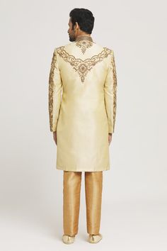 Gold sherwani with all-over zardozi and stone hand embroidery. Comes with gold pant. - Aza Fashions Semi-stitched Gold Kurta With Naqshi, Bollywood Gold Salwar Kameez With Naqshi, Gold Raw Silk Unstitched Suit For Reception, Gold Straight Kurta Churidar For Reception, Gold Churidar With Straight Kurta For Reception, Traditional Gold Raw Silk Wear With Naqshi, Gold Churidar With Intricate Embroidery For Eid, Festive Sherwani With Gold Embroidery For Festivals, Gold Naqshi Sets For Wedding