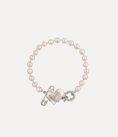 Pearls remain an essential element of the house’s iconography, evoking both a sense of luxury and rebellion. This season's Orietta Pearl bracelet features a row of glass-based Swarovski pearls, adorned with the iconic asymmetric heart motif and an orb at the centre, embellished with a safety pin detail - a nod to Vivienne's punk-inspired, non-conformist aesthetic. Jewelry Accessories Pearl, Vivian Westwood Necklace Green, Vivene Westwood Bracelet, J’adior Bracelet, Vivviene Westwood Bracelet, Vinnie Westwood Bracelet, Vienna Westwood Jewelry, Vivien Westwood Earrings, Vivien Westwood Bracelet