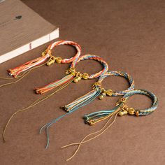 several bracelets are laid out next to a book