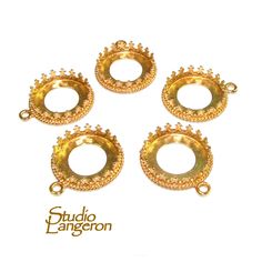 four gold plated metal rings with beading on each one side and the other end