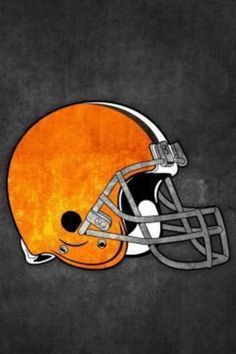 an orange and black football helmet on a gray background with the word browns in it