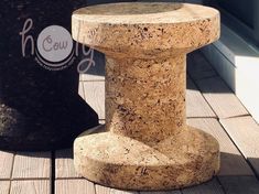 a close up of a stone pillar on a wooden floor next to a black fire hydrant