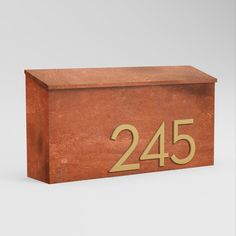 a brick box with the number twenty five in gold on it's front side