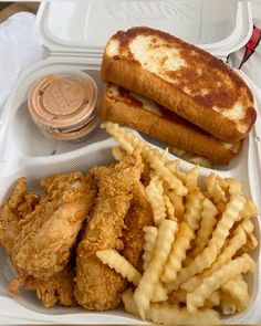 a sandwich and french fries in a styrofoam container