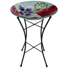 a colorful flowered bowl on a metal stand