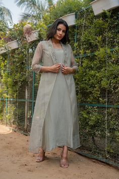 Sage Maxi Jacket Dress, Chinnon Silk and Organza, Long Maxi with Shrug, Indo Western Outfits, Partywear Readymade Dress, Long Dress Women Fabric - Chinnon Silk and Organza Sleeve - 3/4 Sleeves Work - Embroidery on Borders  Color - Sage Green Size - (XS), (S), (M), (L), (XL), (2XL) Length of the Dress- 50 Cm This stunning sage maxi jacket dress combines the elegance of chinnon silk with the airy texture of organza. The ensemble features a maxi dress paired with a coordinating shrug, offering a ve Organza Jacket Outfit Indian, Formal Spring Nehru Jacket With Zari Work, Spring Floor-length Dress With Zari Work, Spring Evening Anarkali Dress, Elegant Front Open Sets For Spring, Fitted Nehru Jacket With Long Sleeves For Party, Fitted Long Sleeve Nehru Jacket For Party, Silk Dress With Zari Work For Spring, Spring Silk Dress With Zari Work