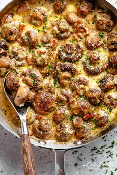 a skillet filled with meatballs and cheese