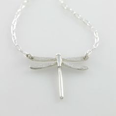 Part of my Spirit Animal collection, this whimsical and pretty little dragonfly pendant will add a bit of charm to any outfit. Handmade in tarnish-resistant sterling silver, each unique pendant is embellished with the texture of a bodhi leaf on each wing. Choose from small and large varieties. Comes on a sterling silver chain that is adjustable between 14 and 17 inches depending on your preference. Pendant is available in small or large. Looks great by itself or styled with your other jewelry an Dainty Sterling Silver Dragonfly Jewelry, Dainty Silver Dragonfly Jewelry, Elegant Sterling Silver Dragonfly Jewelry, Dragonfly Shaped Sterling Silver Jewelry Gift, Sterling Silver Dragonfly Jewelry Gift, Nickel-free Sterling Silver Dragonfly Jewelry, Elegant Sterling Silver Dragonfly Necklace, Handmade Sterling Silver Dragonfly Jewelry, Sterling Silver Dragonfly Necklace