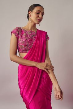 Fuchsia pink solid pre-draped lehenga saree with drape details on the waist. Paired with a short sleeves boat neck blouse with floral embroidery using sequins, beads, cutdana and dangling glass beads highlights. - Aza Fashions Bollywood Style Art Silk Pre-draped Saree With Sheer Dupatta, Dola Silk Pre-draped Saree With Sheer Dupatta For Diwali, Bollywood Dola Silk Pre-draped Saree For Diwali, Bollywood Style Pre-draped Georgette Saree For Diwali, Floor-length Pre-draped Saree For Diwali, Fitted Bollywood Style Pre-draped Saree For Festive Occasions, Bollywood Style Pre-draped Saree For Festivals, Pre-draped Saree For Reception And Diwali, Festive Draped Art Silk Sets