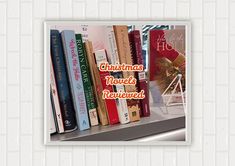 a book shelf filled with lots of books on top of a white brick wall next to a window