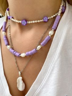 Three different boho summer necklaces with purple flowers, purple beads and freshwater pearls in different sizes and shapes. Combine them all together or wear them separetely as well. In Christina Christi Jewels store you can see more than 50 designs in Women's Necklaces. You can have them in 2-4 Days with DHL EXPRESS SHIPPING MATERIALS - Caoutchouc Beads. - Freshwater Pearls. - Stainless Steel Chain in Silver Color. - Metal Parts. - Adjustable Necklaces DIMENSIONS - Purple Flowers Necklace has Handmade Purple Necklaces For Beach, Handmade Purple Beaded Necklace For Summer, Handmade Purple Beach Necklaces, Summer Purple Beaded Necklaces With Colorful Beads, Summer Purple Beaded Necklace With Colorful Beads, Summer Gift Purple Beaded Necklaces, Handmade Purple Beaded Necklaces For Beach, Handmade Purple Pearl Necklace With Round Beads, Handmade Purple Pearl Necklaces