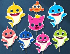 a bunch of little sharks that are on sticks