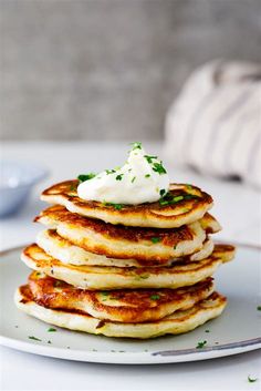 a stack of pancakes with whipped cream on top