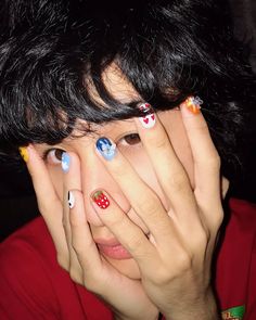 a woman with her hands on her face and nails painted to look like the characters from disney's mickey mouse