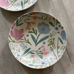 two plates with flowers painted on them