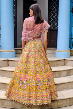 Yellow lehenga with big floral motifs, green thread leaves, foil and mirror embroidery. Paired with blouse and pink tulle dupatta.
Component: 3
Pattern: Embroidered
Type Of Work: Floral
Neckline: Square
Sleeve Type: Sleeveless
Fabric: Organza, Dupatta: Tulle
Color: Yellow
Other Details: 
Embroidered blouse
Cutwork dupatta
Floral pattern
Occasion: Bride,Destination Wedding - Aza Fashions Yellow Organza Lehenga, Aneesh Agarwaal, Blouse Yoke, Indian Designs, Big Floral, Mirror Embroidery, Floral Lehenga, Yellow Lehenga, Organza Lehenga