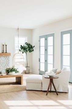 a living room filled with furniture and a fire place next to a door that leads to a patio