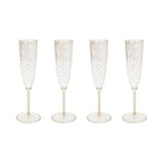 four champagne glasses with gold rims on a white background