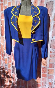 "A colorful eye catching dress and short jacket outfit by Lori Weidner.  Bust 39\"  shoulder to waist line 13\"  arm hole 7.75\"      Dress waist 29\"  hip 29\"  waist to hem 22.5\"     Jacket. Bust 39\"  shoulder to empire waist 15\"  sleeves 25\"  A classic suite dress set." Summer Party Blue Blazer, Blue Summer Party Blazer, Retro Fitted Party Blazer, Fitted Retro Blue Blazer, Yellow Fitted Party Blazer, Fitted Yellow Party Blazer, Retro Fitted Blue Blazer, Suite Dress, Short Jacket Outfit