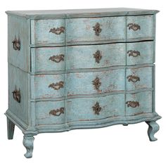 an old dresser with many drawers and knobs on the doors is painted aqua blue