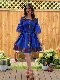 This Beautiful Dress boasts a Traditional Mexican floral design combined with a modern style dress. The elastic bodice combined with the bell sleeves makes it fun and flirty. It's made out of fine Mexican cotton and has elastic around the top for a tighter fit. This dress is handmade and hand embroidered by Mexican Artisans in Oaxaca, Mexico. This dress comes in one size: Small/Medium Purchase the shoes modeled here: https://www.etsy.com/es/listing/830412617/tacon-artesanal-de-bloque-zapato?ref= Fitted Summer Dress With Embroidered Sleeves, Fitted Blue Fiesta Dresses, Fitted Blue Dress For Fiesta, Blue Fitted Dress For Fiesta, Bohemian Fitted Dress With Embroidered Sleeves, Fitted Bohemian Dress With Embroidered Sleeves, Bohemian Dress With Embroidered Bell Sleeves, Bohemian Embroidered Bell Sleeve Dresses, Blue Bell Sleeve Summer Dress