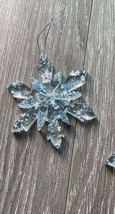 a snowflake ornament on a wooden surface