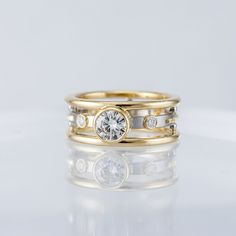 two gold wedding rings with diamonds on top, one is white and the other is yellow