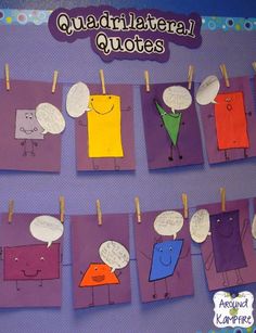 some paper cut out with different colors and shapes on them, hanging from clothes pins