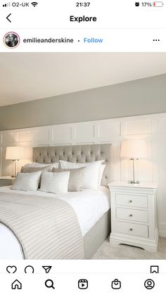 a white bed sitting in a bedroom next to two lamps