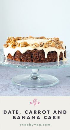 a cake sitting on top of a glass plate covered in frosting and walnuts