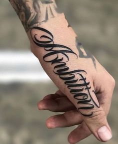 a person with a tattoo on their hand