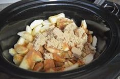 a crock pot filled with food sitting on top of a table