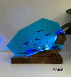 a blue glass sculpture on top of a wooden base