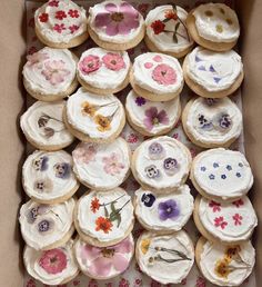 a box filled with lots of decorated cookies