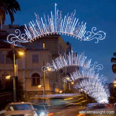 a street with cars driving down it at night