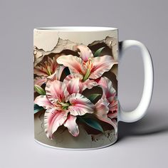 a white coffee mug with pink flowers painted on the front and side, against a gray background